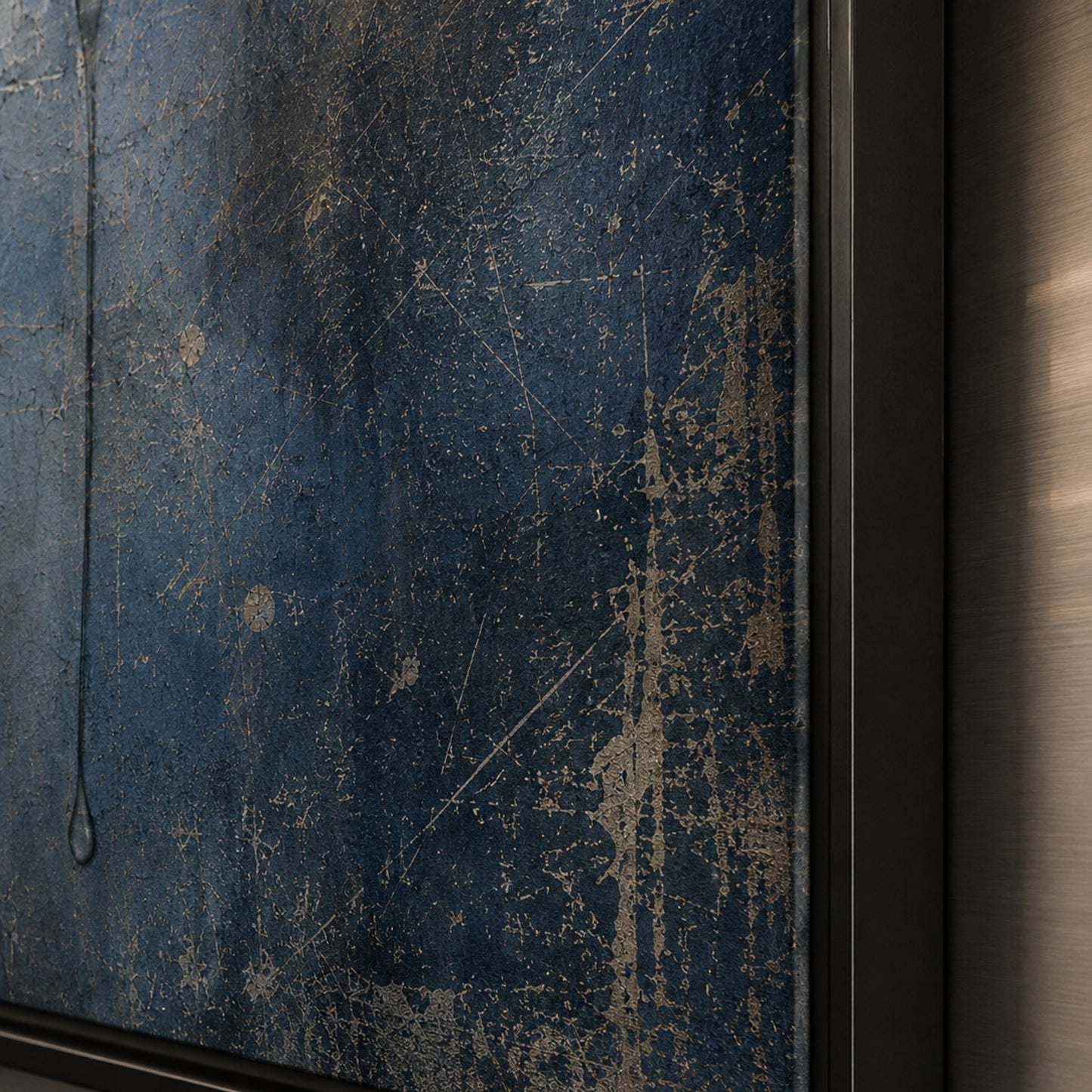 Framed dark blue abstract artwork with a circular trace and downward stain displayed in a contemporary interior