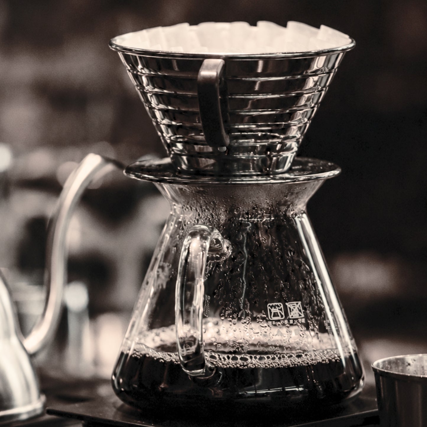 Framed minimal coffee brewing photography from The Pour displayed in a contemporary interior